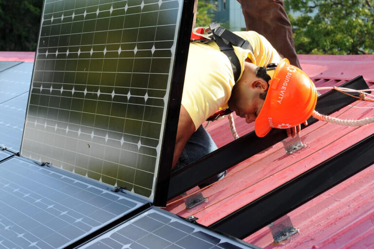 A Simple Guide to How Solar Panels Work (For Homeowners) in 2025 Meta Description: Learn how solar panels work for homeowners in 2025. This simple guide covers solar energy systems, costs, savings, and the Federal Solar Tax Credit to help you save with residential solar panels before it expires on December 31, 2025. Keywords: how solar panels work, solar panel cost, Federal Solar Tax Credit 2025, solar energy systems, solar energy savings, residential solar panels, solar power for home Introduction: Understanding Solar Panels for Your Home With solar energy powering over 7% of U.S. homes in 2025, residential solar panels are a popular way to slash electricity bills, reduce carbon footprints, and boost home value. The 30% Federal Solar Tax Credit, expiring for residential installations on December 31, 2025, makes now an ideal time to explore solar energy systems. But how do solar panels actually work? This beginner-friendly guide explains the process in simple terms, covering components, benefits, and costs to help homeowners make informed decisions. For personalized quotes, visit EnergySage to connect with trusted installers. How Do Solar Panels Work? A Simple Explanation Solar panels convert sunlight into electricity through a straightforward process. Here’s how it works, step by step: Solar Panels Capture Sunlight: What Happens: Solar panels, made of photovoltaic (PV) cells, absorb sunlight. Each cell contains silicon, which generates a small electric current when hit by photons (light particles). Key Component: Most panels use monocrystalline cells (19–22% efficiency) for higher output or polycrystalline cells (15–17%) for lower cost. A 7.2 kW system typically has 18–20 panels (400W each). Inverters Convert Electricity: What Happens: Solar panels produce direct current (DC) electricity, but homes use alternating current (AC). Inverters convert DC to AC for household use. Key Component: String inverters connect multiple panels (cost: $1,000–$2,000), while microinverters (one per panel, $100–$200 each) optimize performance in shaded areas. Electricity Powers Your Home: What Happens: Converted AC electricity flows to your home’s electrical panel, powering appliances, lights, and devices. Any excess energy can be stored or sent to the grid. Key Component: A net meter tracks energy sent to/received from the grid, reducing bills via net metering (credits for excess energy). Battery Storage (Optional): What Happens: Excess energy can be stored in a solar battery (e.g., Tesla Powerwall, 13.5 kWh) for use at night, during outages, or under time-of-use (TOU) rates, saving $500–$1,500/year in high-rate states. Key Component: Lithium-ion batteries (90–96% efficiency) cost $7,000–$18,000 but qualify for the Federal Solar Tax Credit. Grid Connection: What Happens: Most systems are grid-tied, using the utility grid as backup when solar production is low (e.g., at night or cloudy days). Net metering credits excess energy, lowering bills. Key Component: A Permission to Operate (PTO) from your utility ensures safe grid connection. This process allows a 7.2 kW system to generate ~10,800 kWh/year in sunny states (e.g., California), covering most or all of an average household’s 10,632 kWh annual usage. Benefits of Solar Panels for Homeowners Installing solar energy systems offers significant advantages in 2025: Energy Savings: A 7.2 kW system saves $1,000–$3,500/year, depending on state electricity rates ($0.11–$0.33/kWh). Lifetime savings reach $31,000–$100,000 over 25 years, per EnergySage. Federal Solar Tax Credit: Saves 30% on installation costs (e.g., $6,600 on a $22,000 system) for systems installed by December 31, 2025. File IRS Form 5695 to claim it. Home Value Boost: Solar homes sell for 4–6.8% more ($15,000–$27,200 for a $400,000 home), per 2021 Zillow and 2019 LBNL studies. Environmental Impact: Cuts ~8,000 lbs of CO2 annually, equivalent to planting 120 trees, appealing to eco-conscious buyers. Energy Independence: Reduces reliance on rising utility rates (2–4% annually) and outages with battery storage. Solar Panel Costs and Savings in 2025 Understanding solar panel costs helps homeowners weigh the investment: Average Cost: A 7.2 kW system costs $18,144–$26,424 ($2.52–$3.67/W), including panels, inverters, mounting, labor, and permitting, per EnergySage. After Tax Credit: The 30% Federal Solar Tax Credit reduces costs to $12,701–$18,497. State incentives (e.g., New York’s 25% tax credit, up to $5,000) can save more. Check DSIRE for local programs. Battery Costs: Adding a 10–13.5 kWh battery costs $7,000–$18,000, with tax credit savings of $2,100–$5,400. Payback Period: 4–10 years, faster in high-rate states (e.g., CA: $0.33/kWh, 4–6 years) than low-rate states (e.g., ID: $0.11/kWh, 8–12 years). Financing Options: Cash Purchase: Cheapest long-term ($12,701–$18,497 after tax credit). Solar Loans: Zero-down loans add 5.99–8% interest, increasing costs to $26,000–$31,000. Leases/PPAs: No upfront cost but miss tax credits; payments ($50–$150/month) may exceed savings. For cost comparisons, contact trusted installers like Sunrun. Key Considerations for Homeowners Before installing solar panels, consider these factors to maximize solar energy savings: Roof Suitability: South-facing, unshaded roofs with 15–40° slopes maximize output. Complex roofs (steep, tiled) may add $500–$2,000 to installation costs. Energy Usage: Review utility bills to size your system. An average household (10,632 kWh/year) needs a 7.2 kW system; high-usage homes (>15,000 kWh) may need 10–12 kW. Incentives: Combine the Federal Solar Tax Credit with state rebates (e.g., California’s SGIP, $150/kWh for batteries) to cut costs by 30–50%. Check DSIRE. Battery Storage: Essential for outages or TOU rates, but adds $7,000–$18,000. Choose high-efficiency batteries like Tesla Powerwall 3 (90% efficiency, 13.5 kWh). Installer Quality: Work with NABCEP-certified installers to ensure efficiency and 25-year warranties. Compare 3–5 quotes on EnergySage to save 10–20% ($2,000–$4,000). Net Metering: Available in most states, it credits excess energy at retail rates (e.g., 1:1 in Arizona), reducing bills. Verify with your utility provider. Common Misconceptions About Solar Panels “Solar Panels Don’t Work on Cloudy Days”: Panels generate 10–25% of normal output on cloudy days, and grid-tied systems use utility power as backup. “Solar Is Too Expensive”: After tax credits and incentives, net costs are $12,701–$18,497 for a 7.2 kW system, with paybacks in 4–10 years. “Panels Require Constant Maintenance”: Panels need cleaning every 6–12 months ($150–$300) and occasional inspections, with 25–30-year lifespans. “All Solar Systems Are the Same”: Monocrystalline panels (19–22% efficiency) outperform polycrystalline (15–17%), and inverter/battery choices impact performance. FAQs About How Solar Panels Work in 2025 How much electricity do solar panels produce? A 7.2 kW system generates ~10,800 kWh/year in sunny states (CA, AZ) or 8,600 kWh in cloudy states (WA, ME), covering most of an average household’s 10,632 kWh/year. How much do solar panels cost in 2025? A 7.2 kW system costs $18,144–$26,424 ($2.52–$3.67/W). After the 30% Federal Solar Tax Credit, costs drop to $12,701–$18,497. Can solar panels power my home at night? Yes, with a solar battery (e.g., 10–13.5 kWh, $7,000–$18,000) or grid connection via net metering. Batteries store daytime energy for nighttime use. Do solar panels work during outages? Grid-tied systems shut off during outages for safety unless paired with a battery (e.g., Tesla Powerwall 3, 13.5 kWh) for backup power (12–48 hours). Is the Federal Solar Tax Credit still available? Yes, the 30% tax credit applies to systems installed by December 31, 2025, saving $5,443–$7,927 on a $18,144–$26,424 system. It’s nonrefundable but rolls over. Conclusion: Go Solar with Confidence in 2025 Solar panels work by converting sunlight into electricity through photovoltaic cells, inverters, and optional batteries, offering homeowners solar energy savings of $1,000–$3,500/year and a 4–6.8% home value boost. With solar panel costs at $12,701–$18,497 after the Federal Solar Tax Credit (expiring December 31, 2025), 2025 is the perfect year to invest in solar energy systems. Start by comparing quotes from trusted installers like Sunrun on EnergySage and check state incentives on DSIRE to maximize savings. Embrace clean energy, cut bills, and power your home sustainably! Disclaimer: Solar costs and savings vary by location, usage, and installer. Consult a tax professional for Federal Solar Tax Credit advice and verify installer credentials before signing contracts.